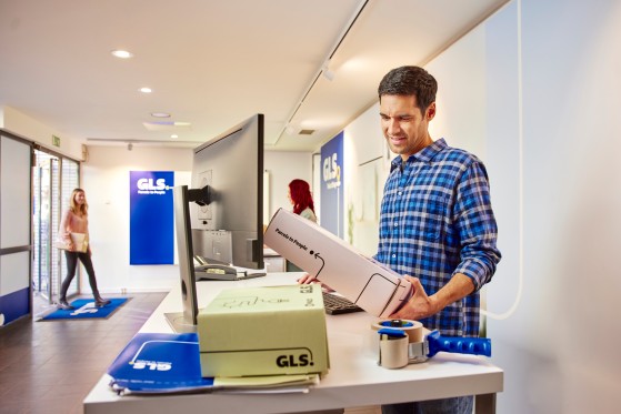 Man-looking-at-a-parcel-in-a-Parcel-Shop