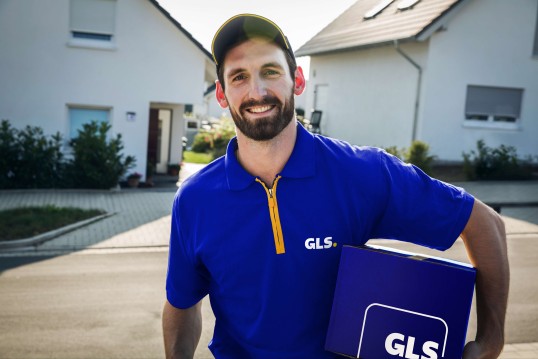 GLS delivery driver stands on a street