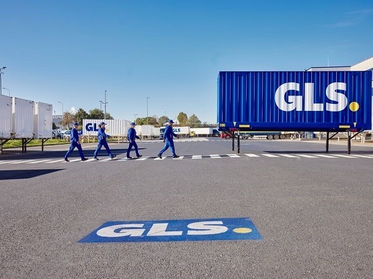 GLS employees walk across a zebra crossing on the depot premises