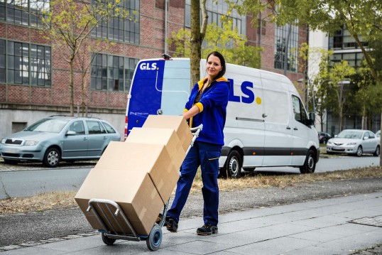 GLS delivery van driving on a forest road