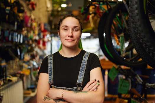 Happy_female_millennial_standing_in_gls_store