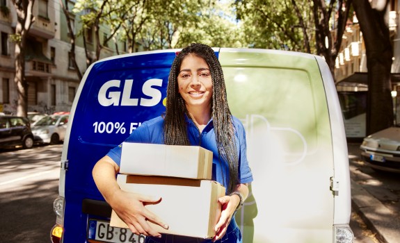 GLS driver woman with a parcel on her arms