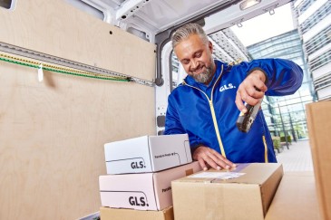 Smiling teeneger with available parcel in front of stairs